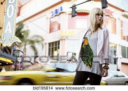 Picture - Caucasian woman standing on city street. Fotosearch