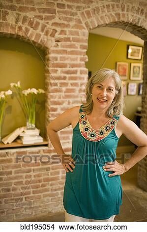 Picture - Caucasian woman standing with hands on hips. Fotosearch