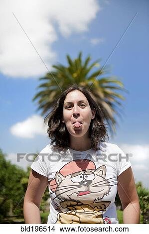 Picture - Caucasian woman sticking out tongue. Fotosearch