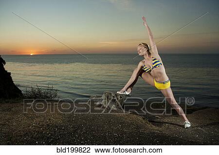 Caucasian woman stretching near ocean View Large Photo Image Stock Image - Caucasian woman stretching near ocean. Fotosearch