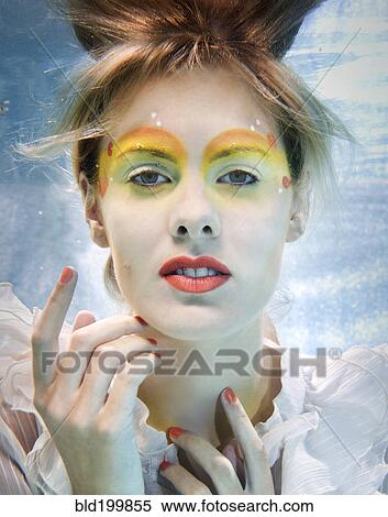 Stock Photography - Caucasian woman swimming under water. Fotosearch
