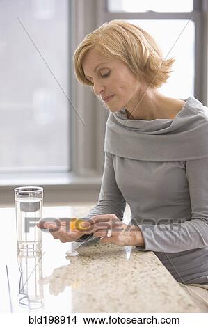Caucasian woman taking medicine View Large Photo Image Picture - Caucasian woman taking medicine. Fotosearch