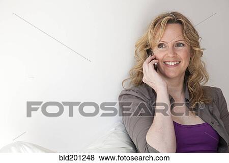 Stock Photo - Caucasian woman talking on cell phone. Fotosearch
