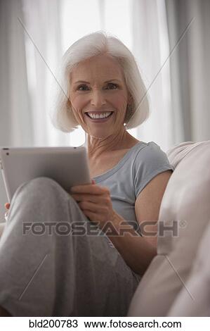 Stock Image - Caucasian woman using digital tablet. Fotosearch