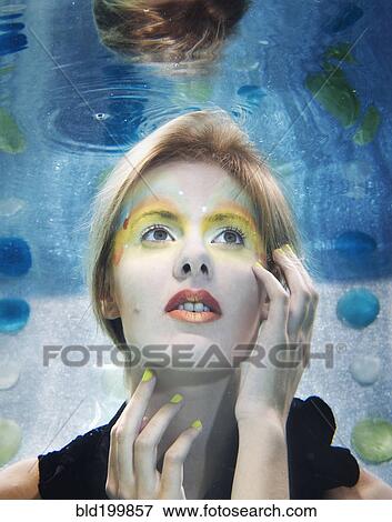 Caucasian woman with makeup on under water View Large Photo Image Stock Photo - Caucasian woman with makeup on under water. Fotosearch
