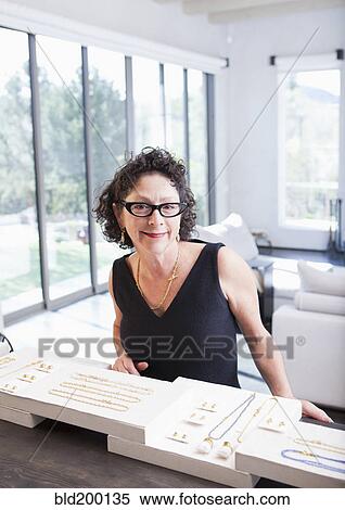Stock Photography - Caucasian woman working in jewelry store. Fotosearch