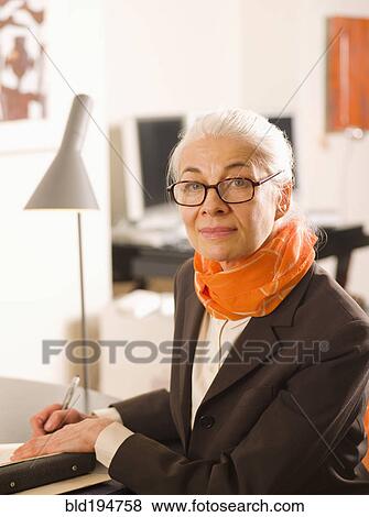 Stock Photo - Caucasian woman writing in notebook. Fotosearch