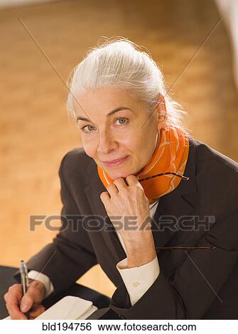Caucasian woman writing in notebook View Large Photo Image Stock Photograph - Caucasian woman writing in notebook. Fotosearch