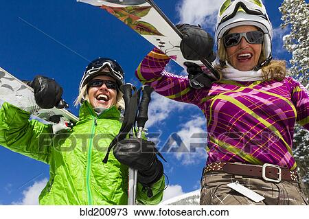 Stock Image - Caucasian women skiing. Fotosearch