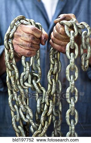 Caucasian worker holding chains View Large Photo Image Stock Image - Caucasian worker holding chains. Fotosearch