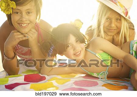 Children in bikinis laying on towel View Large Photo Image Stock Photo - Children in bikinis laying on towel. Fotosearch