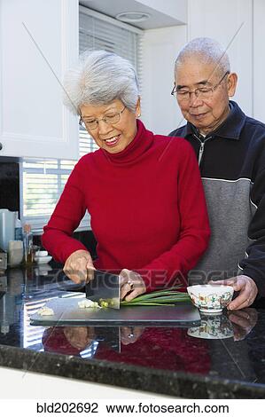 Chinese couple chopping onions in kitchen View Large Photo Image Stock Image - Chinese couple chopping onions in kitchen. Fotosearch