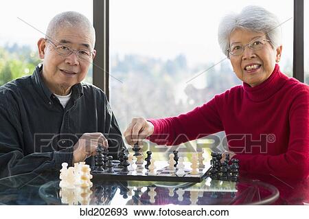 Chinese couple playing chess View Large Photo Image Stock Image - Chinese couple playing chess. Fotosearch