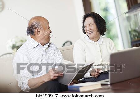 Chinese couple with book and laptop View Large Photo Image Stock Photo - Chinese couple with book and laptop. Fotosearch