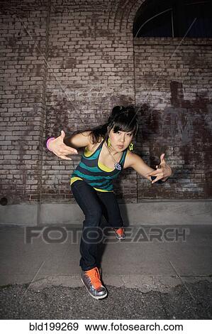 Chinese woman breakdancing in urban area View Large Photo Image Stock Photo - Chinese woman breakdancing in urban area. Fotosearch
