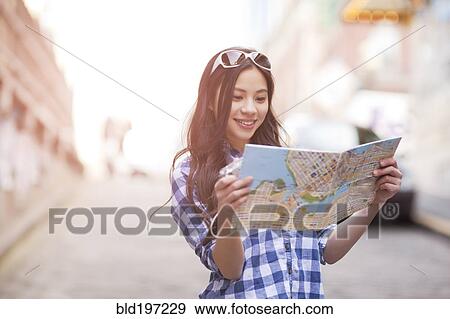 Chinese woman looking at map View Large Photo Image Stock Photo - Chinese woman looking at map. Fotosearch
