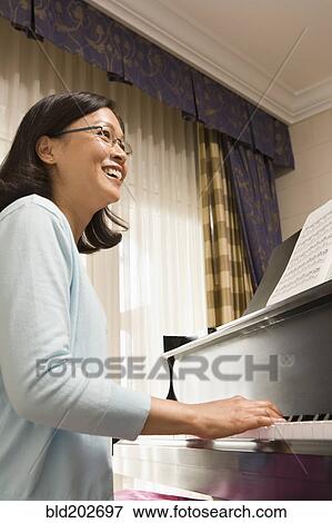 Chinese woman playing piano View Large Photo Image Stock Photo - Chinese woman playing piano. Fotosearch