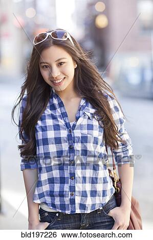 Stock Photograph - Chinese woman with hands in pockets. Fotosearch