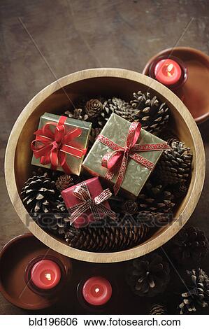 Stock Photograph - Christmas gifts in wooden bowl. Fotosearch