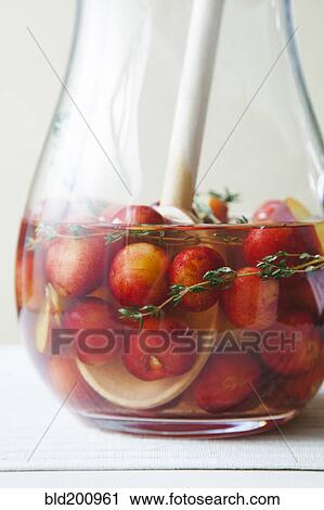 Stock Image - Close up of cherries in liquid. Fotosearch