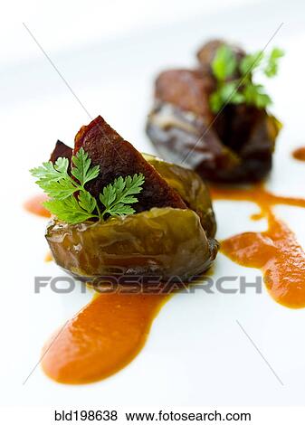 Stock Photo - Close up of fig with chorizo in sauce. Fotosearch