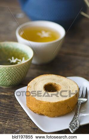 Stock Photography - Close up of jasmine tea and wheat cake. Fotosearch