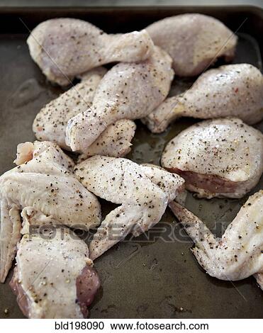 Stock Image - Close up of seasoned raw chicken pieces. Fotosearch