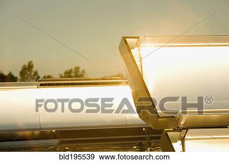 Close up of sun shining on solar panels View Large Photo Image Stock Photo - Close up of sun shining on solar panels. Fotosearch