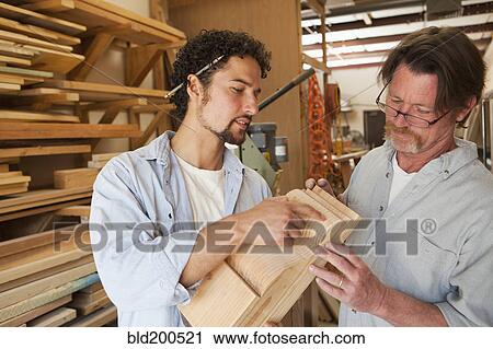Co-workers woodworking in workshop View Large Photo Image Stock Image - Co-workers woodworking in workshop. Fotosearch