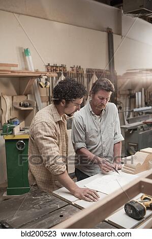 Co-workers woodworking in workshop View Large Photo Image Stock Image - Co-workers woodworking in workshop. Fotosearch