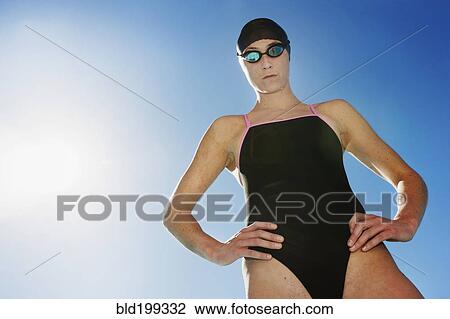 Competitive swimmer with hands on hips View Large Photo Image Stock Image - Competitive swimmer with hands on hips. Fotosearch