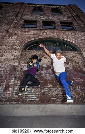 Stock Photo - Couple breakdancing in urban area. Fotosearch
