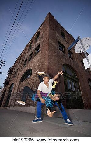 Couple breakdancing in urban area View Large Photo Image Stock Photograph - Couple breakdancing in urban area. Fotosearch