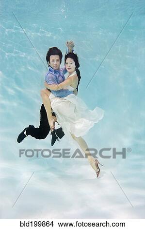 Couple dancing under water View Large Photo Image Picture - Couple dancing under water. Fotosearch