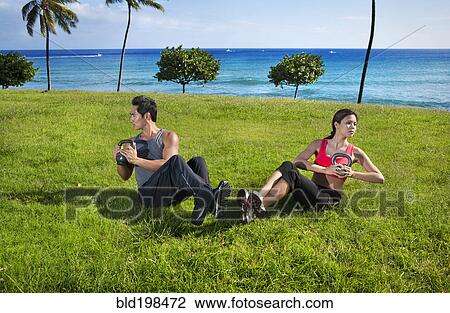 Stock Image - Couple exercising together at waterfront. Fotosearch