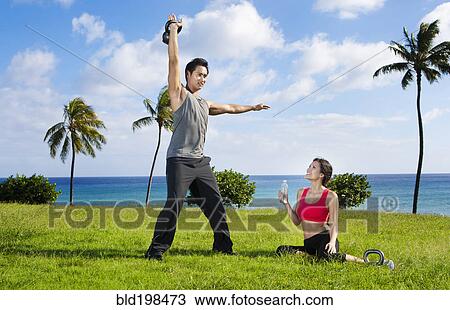 Couple exercising together at waterfront View Large Photo Image Stock Image - Couple exercising together at waterfront. Fotosearch