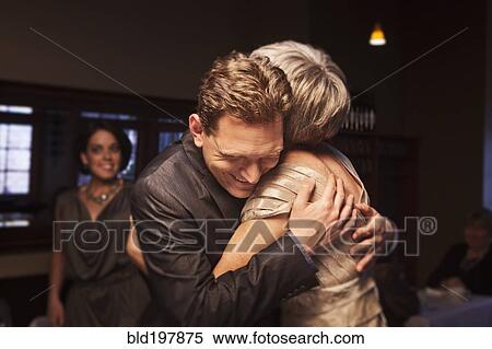 Couple greeting friends in restaurant View Large Photo Image Stock Photography - Couple greeting friends in restaurant. Fotosearch