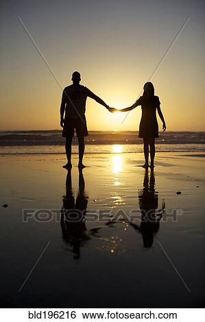Couple holding hands on beach View Large Photo Image Stock Photograph - Couple holding hands on beach. Fotosearch