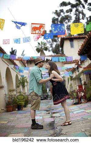 Stock Image - Couple holding hands outdoors. Fotosearch