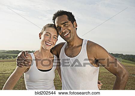 Couple hugging in field View Large Photo Image Picture - Couple hugging in field. Fotosearch