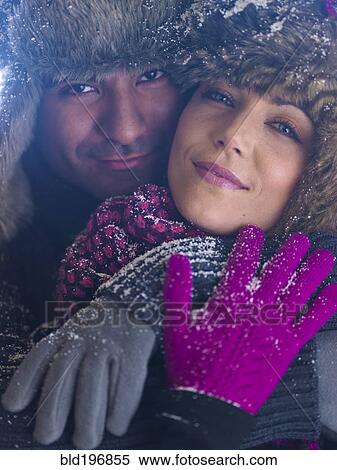 Stock Photography - Couple in fur caps hugging. Fotosearch