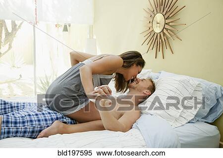 Couple kissing in bed View Large Photo Image Stock Photography - Couple kissing in bed. Fotosearch