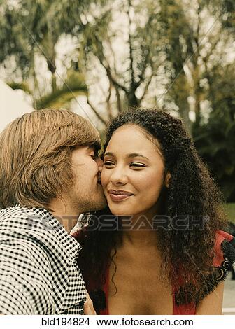 Picture - Couple kissing outdoors. Fotosearch