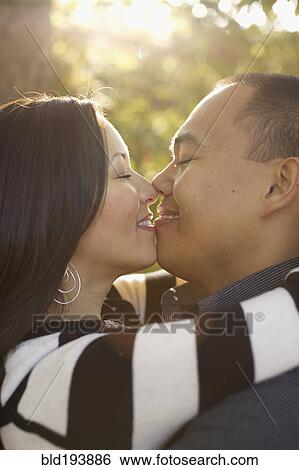 Couple kissing outdoors View Large Photo Image Stock Photograph - Couple kissing outdoors. Fotosearch