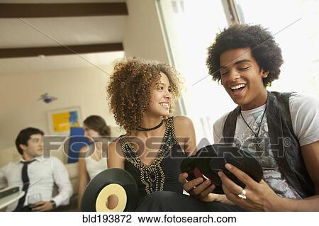 Couple looking at vinyl records View Large Photo Image Stock Image - Couple looking at vinyl records. Fotosearch