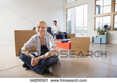 Stock Image - Couple moving into new house. Fotosearch