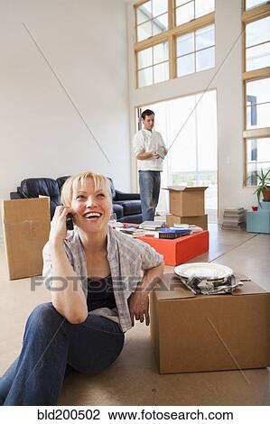 Stock Image - Couple moving into new house. Fotosearch