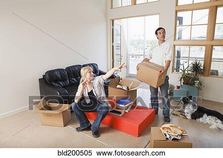 Stock Photography - Couple moving into new house. Fotosearch