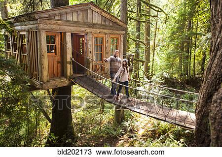 Couple on walkway of remote tree house View Large Photo Image Stock Image - Couple on walkway of remote tree house. Fotosearch