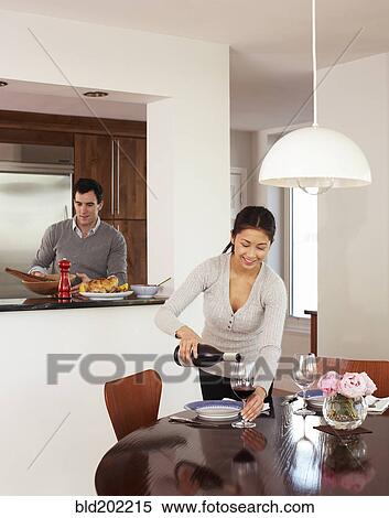 Couple preparing dinner together View Large Photo Image Stock Photography - Couple preparing dinner together. Fotosearch
